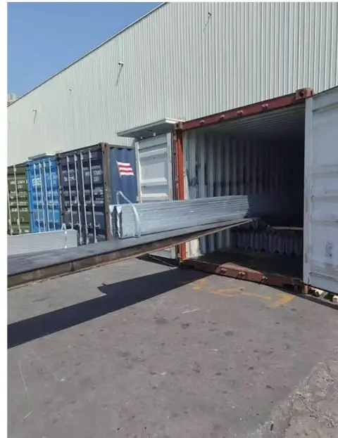 Guardrail materials being loaded into a container