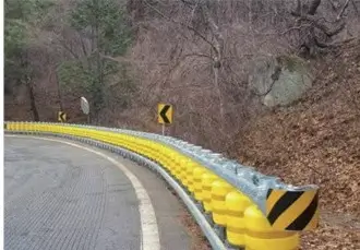 Yellow roller barrier on mountain road